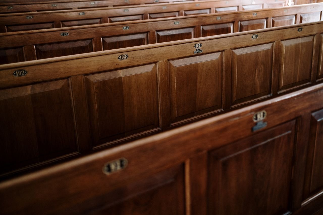 Crafting Captivating Headlines: Your awesome post title goes here Close-up view of wooden pews inside a church, showcasing the intricate design.